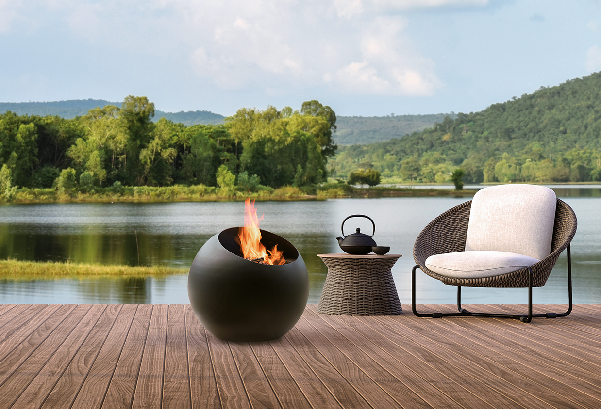 Focus Bubble outdoor brasero, a spherical black steel fire pit standing on the terrace