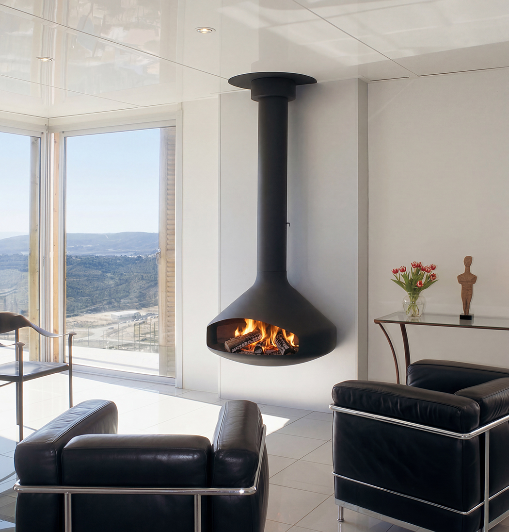 Focus Paxfocus wall-mounted steel fireplace, the angular folded hood sitting against a contemporary wall as a piece of sculpture as much as a fireplace