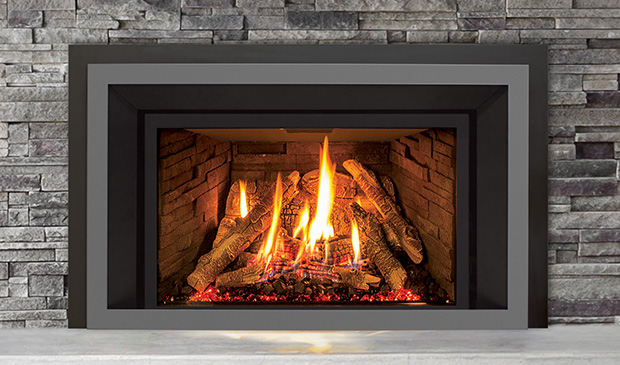 Enviro EX35 gas insert with a two-tone black and grey contemporary surround set into a grey ledgestone fireplace, a tall log fire over a glowing red ember bed, a white marble hearth below