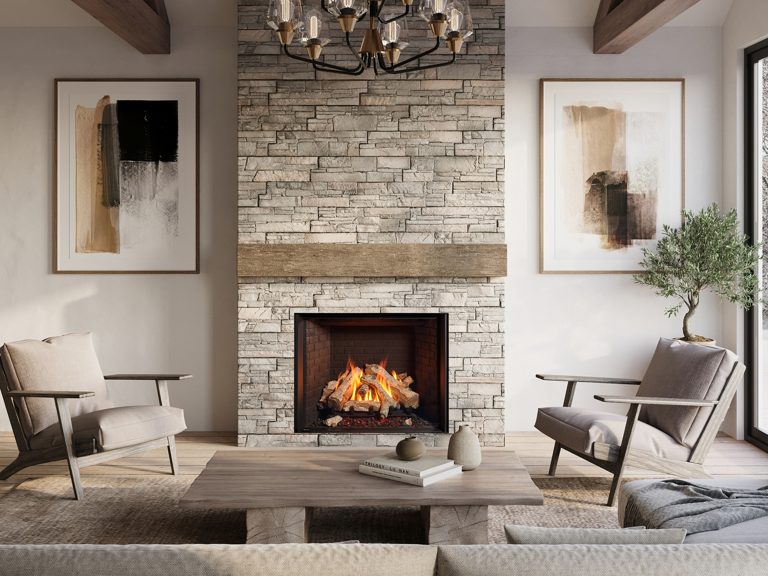 Regency Grandview G1200 gas fireplace with a large log fire, set into a floor-to-ceiling stacked-stone chimney with a reclaimed-wood mantel beam, flanked by framed art and wood-armed chairs