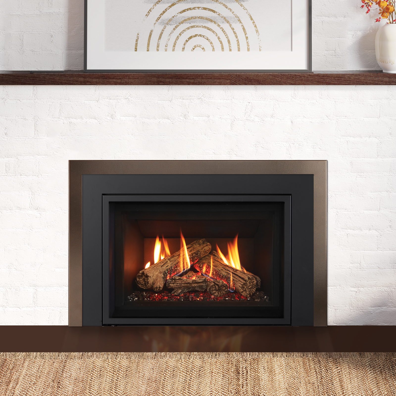 Close, straight-on view of a Regency Gi29LE gas insert with its Infusion Burner flame over a high-definition log set, framed by a bronze face and black trim against white brick