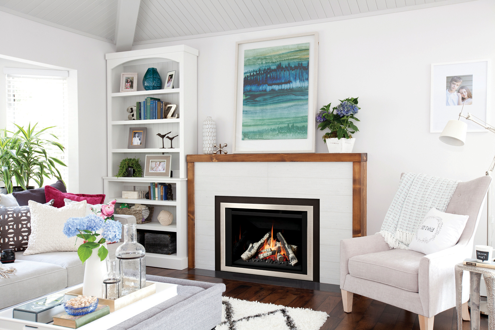 Valor G4 gas insert installed in a bright white-paneled coastal living room with built-in bookshelves and a coffered ceiling