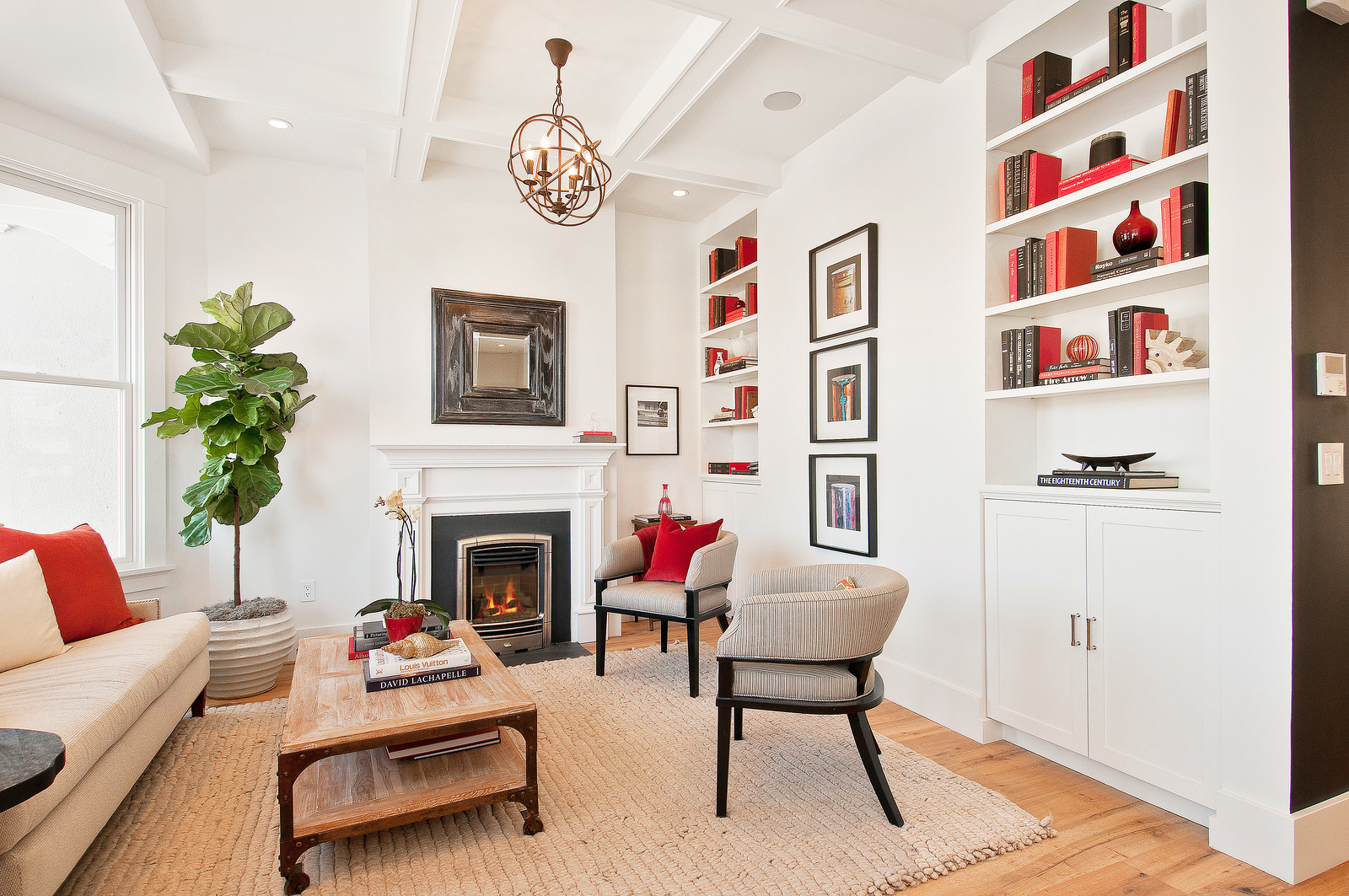 Valor Portrait with a Bolero front in a living room with a coffered ceiling, white mantel, red book accents and an orb chandelier